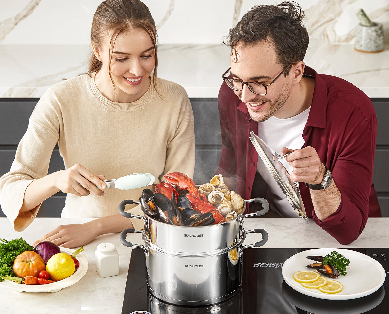 Two people cooking seafood in a kitchen with a modern stove and decor.
