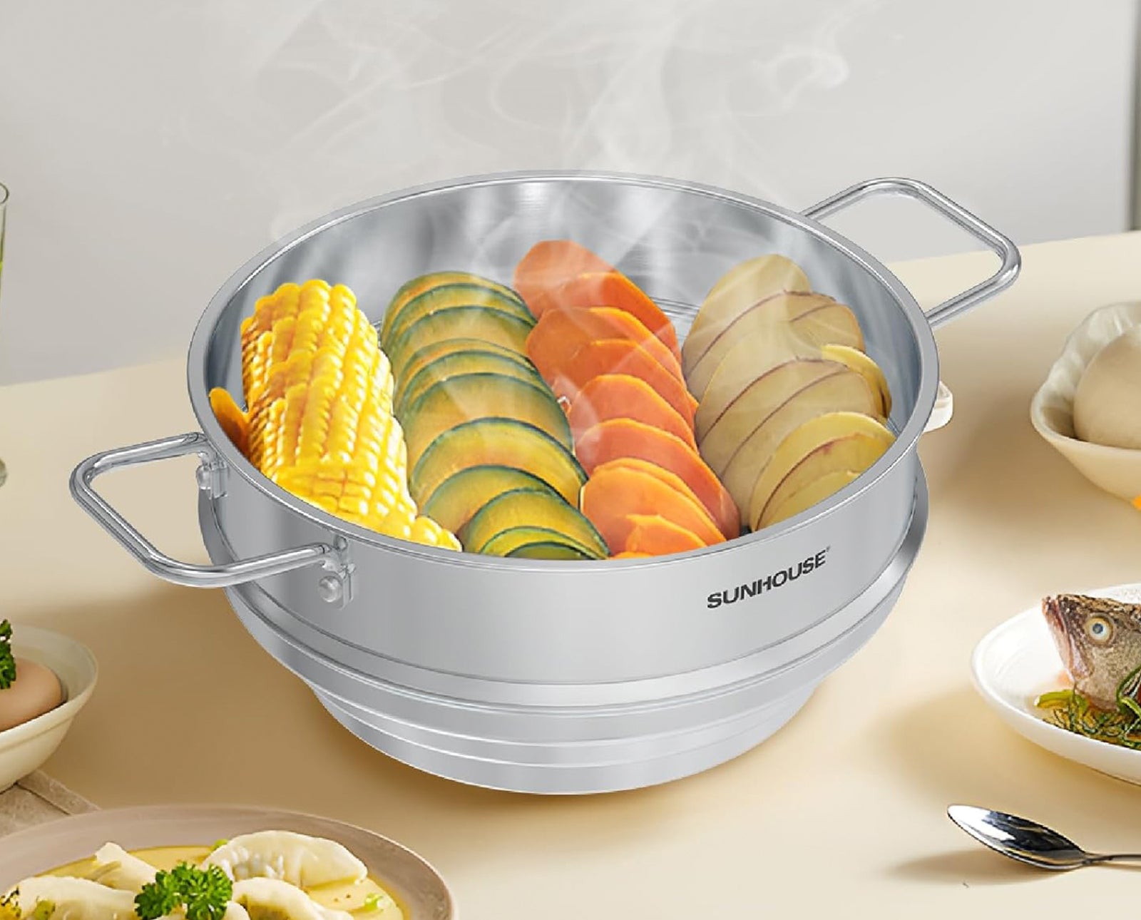 Stainless steel steamer basket with vegetables on a kitchen counter, featuring the Sunhouse brand.