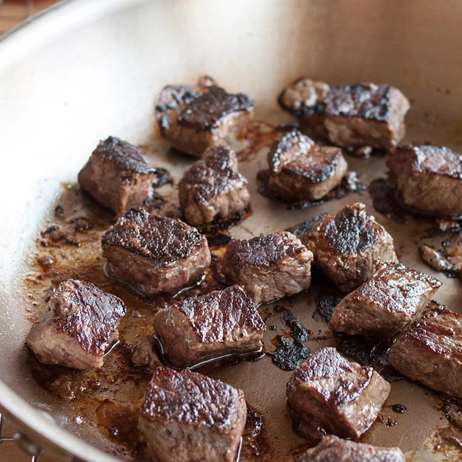 Browned beef cubes in a pan