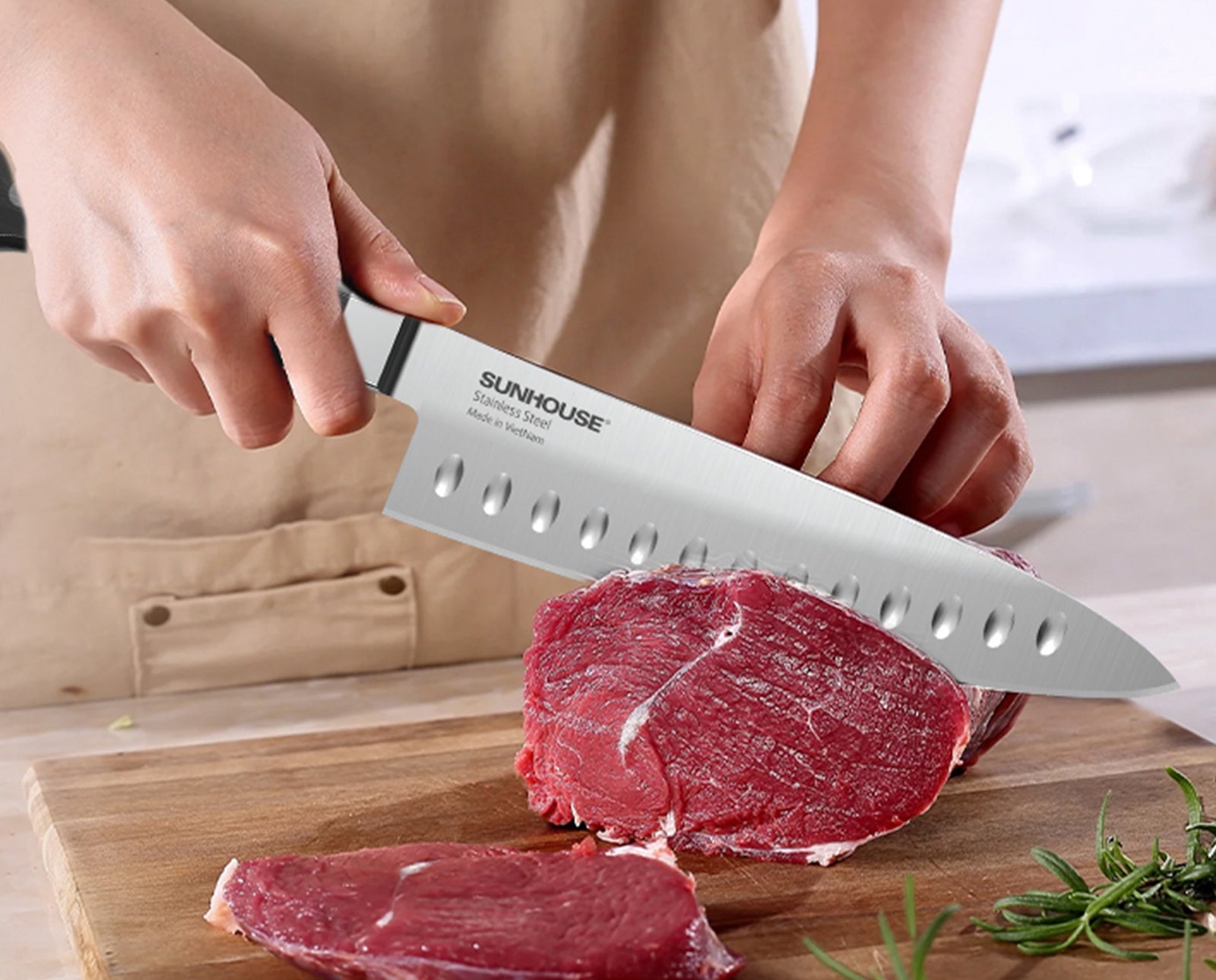 Person using a Sunhouse knife to cut meat on a wooden board