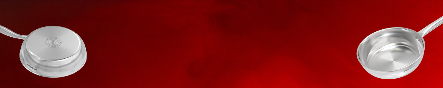 Two silver ladles on a red background