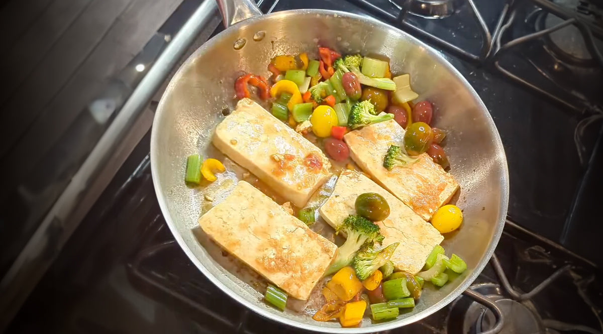 Fried tofu with vegetables in a Sunhouse pan on a stove