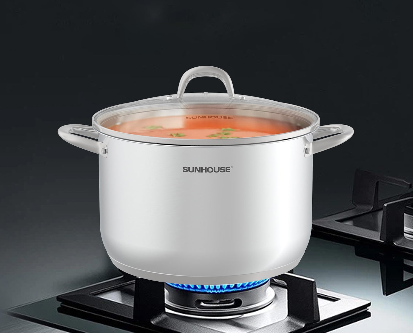 White pot with lid on a stove, brand 'Sunhouse' visible